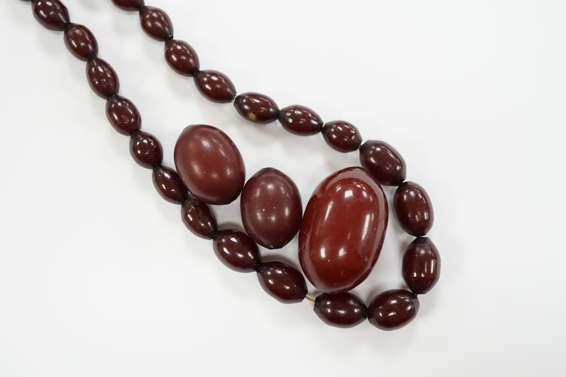 A single strand graduated simulated cherry amber bead necklace(a.f.), gross weight 50 grams.